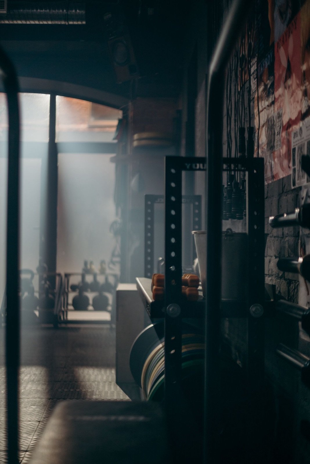 Dramatically lit training room with weights