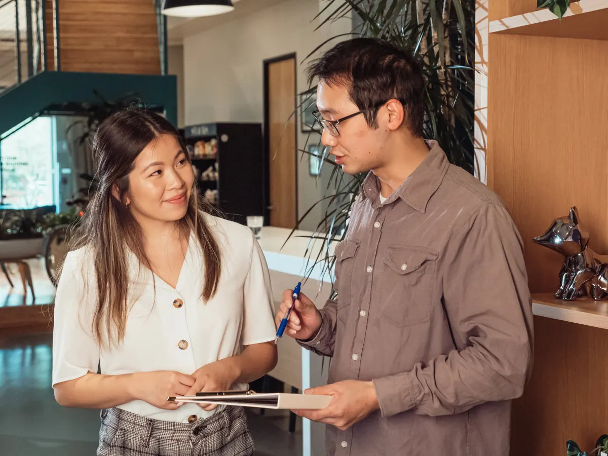 Two people discussing a project face to face